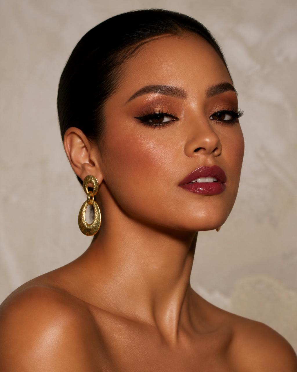 Latina woman with full glam smoky eye and berry lip, editorial portrait