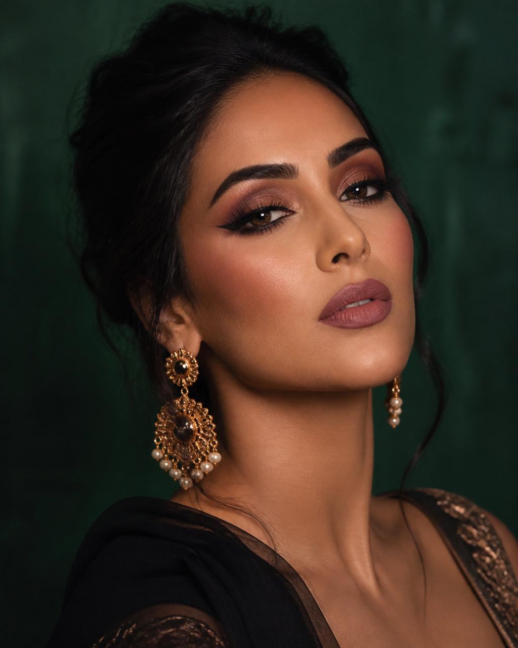Middle Eastern woman with full glam bronze smoky eye, editorial portrait